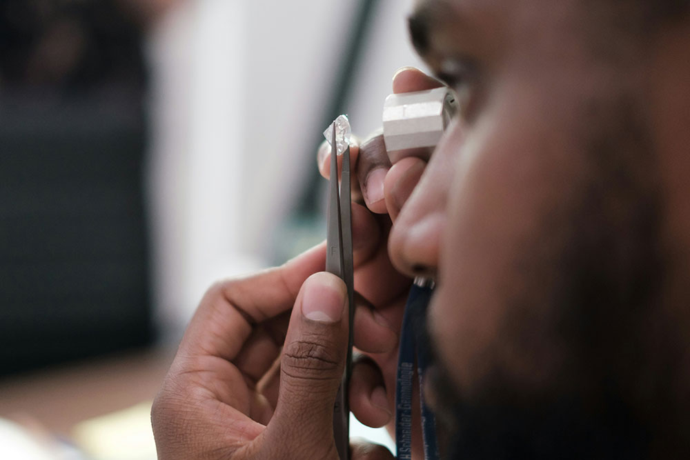 Jeweler inspecting GIA certified diamond